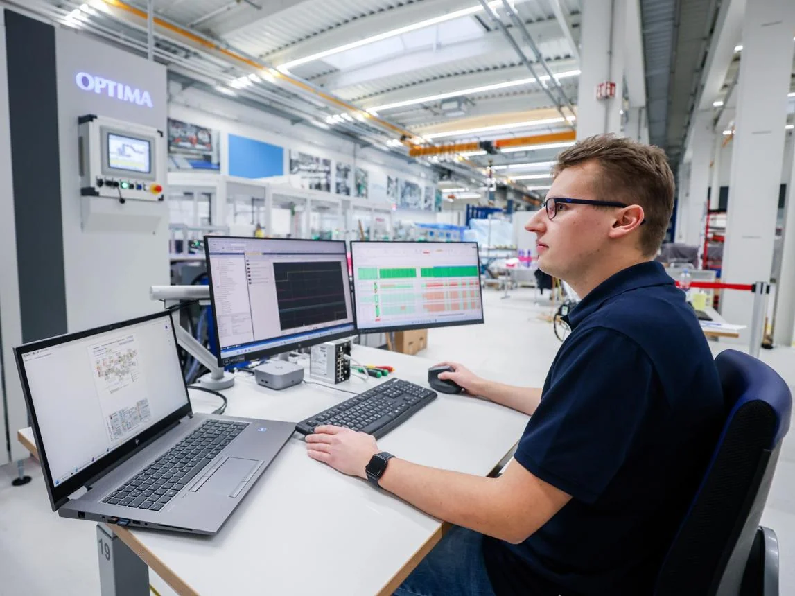 Manufacturing professional using business workstations on a production floor